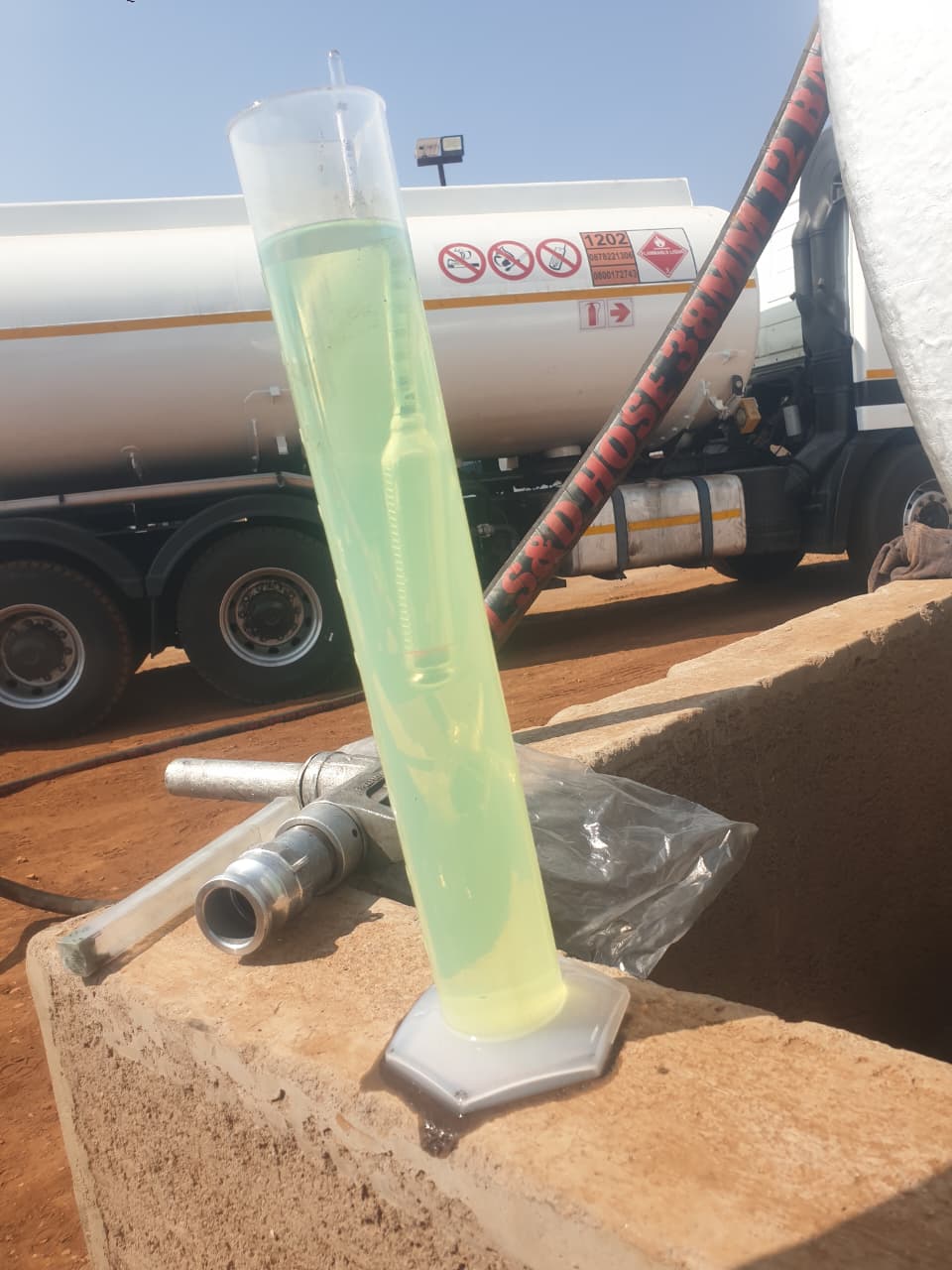 Field fuel sample beside tanker