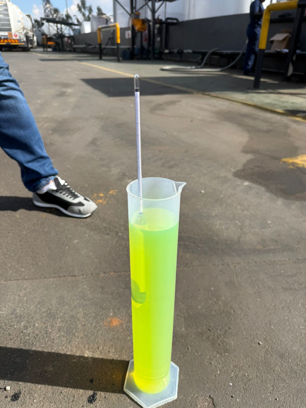 Petrol sample in measuring cylinder for quality test